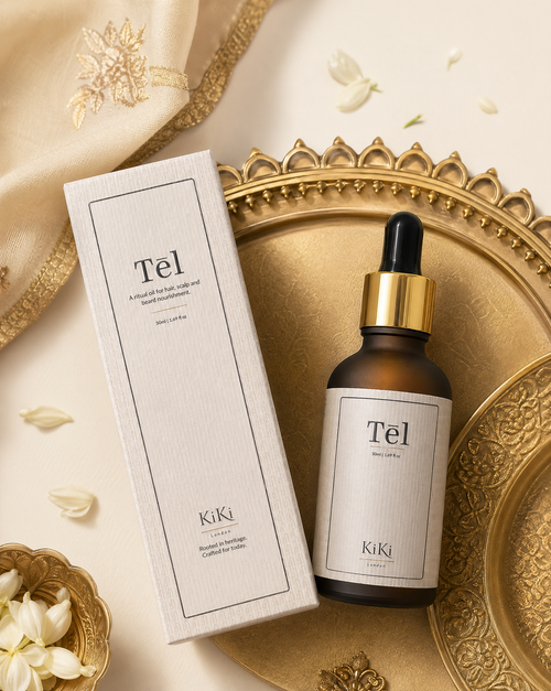 KiKi London Tel skincare product with dropper and packaging on a decorative tray with flowers.
